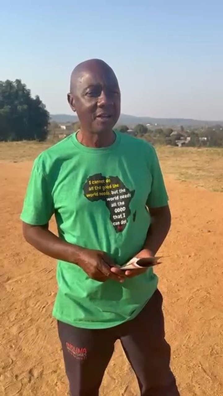 The manager of SizaBantwana speaking to camera on open ground outside the care centre